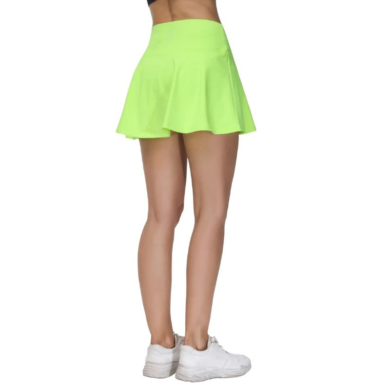 Person wearing a bright green skirt and white sneakers on a white background