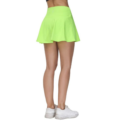 Person wearing a bright green skirt and white sneakers on a white background