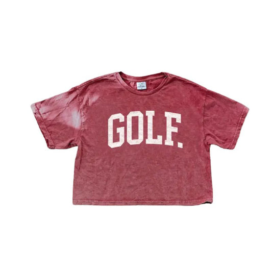 A red mineral washed cropped short sleeve tee with bold white GOLF lettering, displayed on a flat white background.